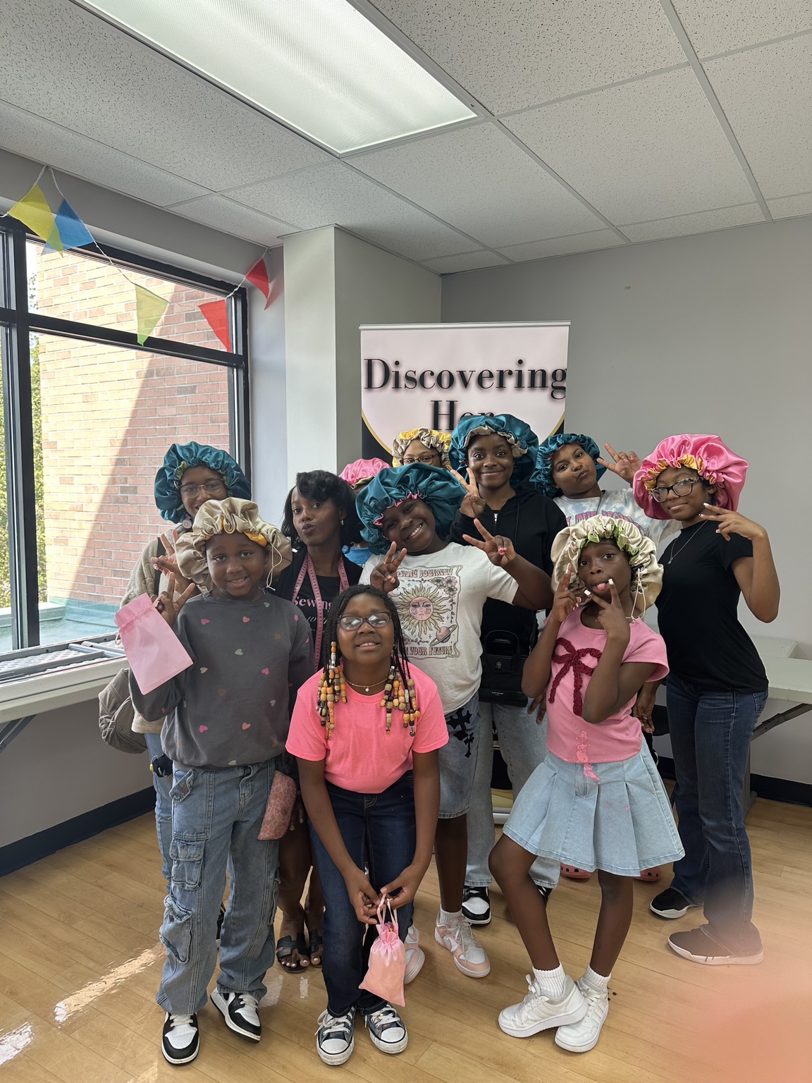 House of Jutan participants wearing bonnets they made at a workshop